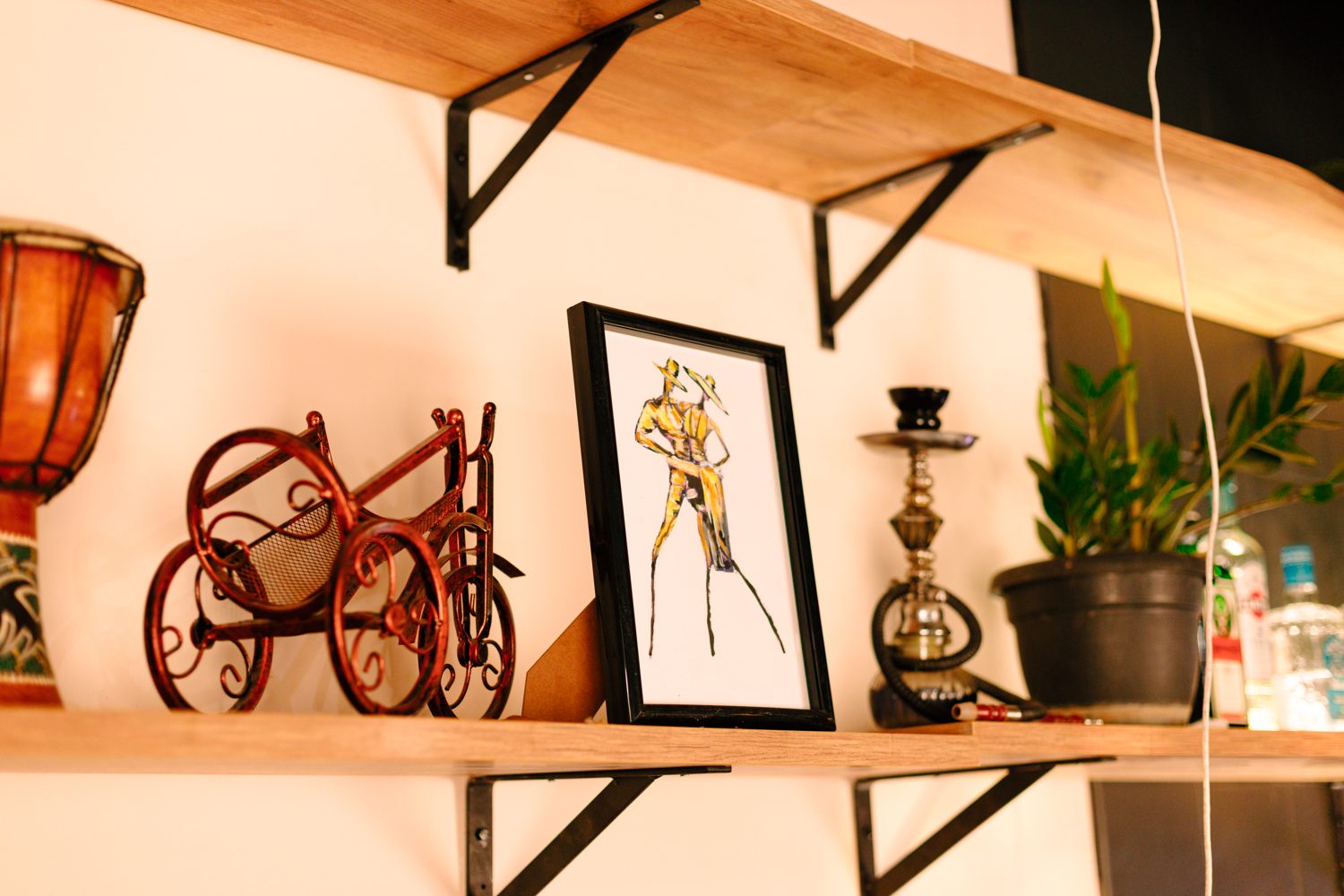 Framed illustration, hookah and plant on the shelf