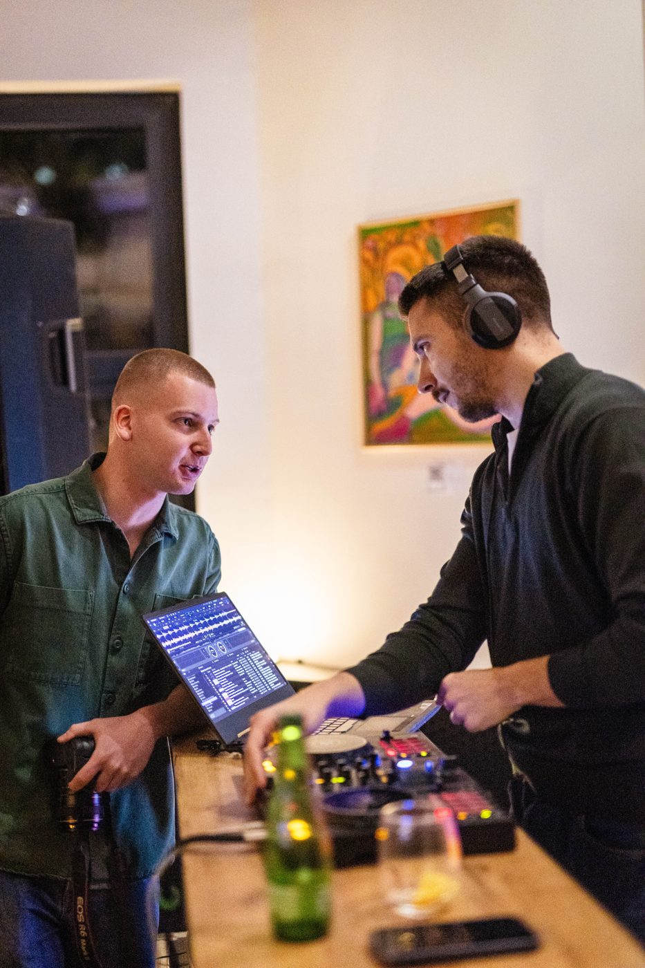 A DJ at the decks talking with a guest at RABOTEKA